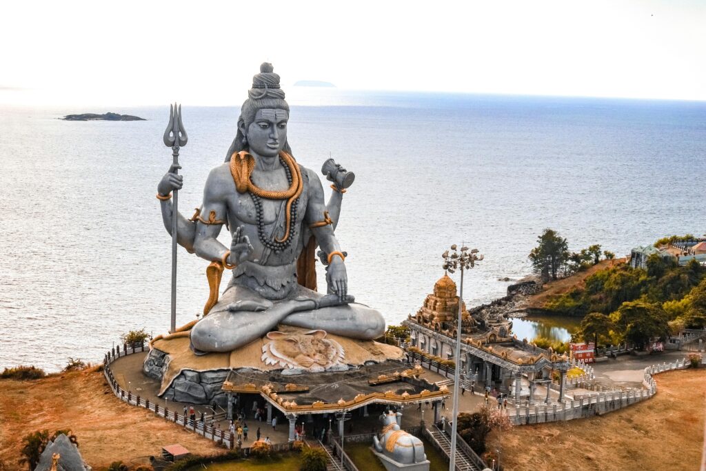 A stunning aerial view of the Murudeshwara Temple with the iconic Shiva statue by the sea.